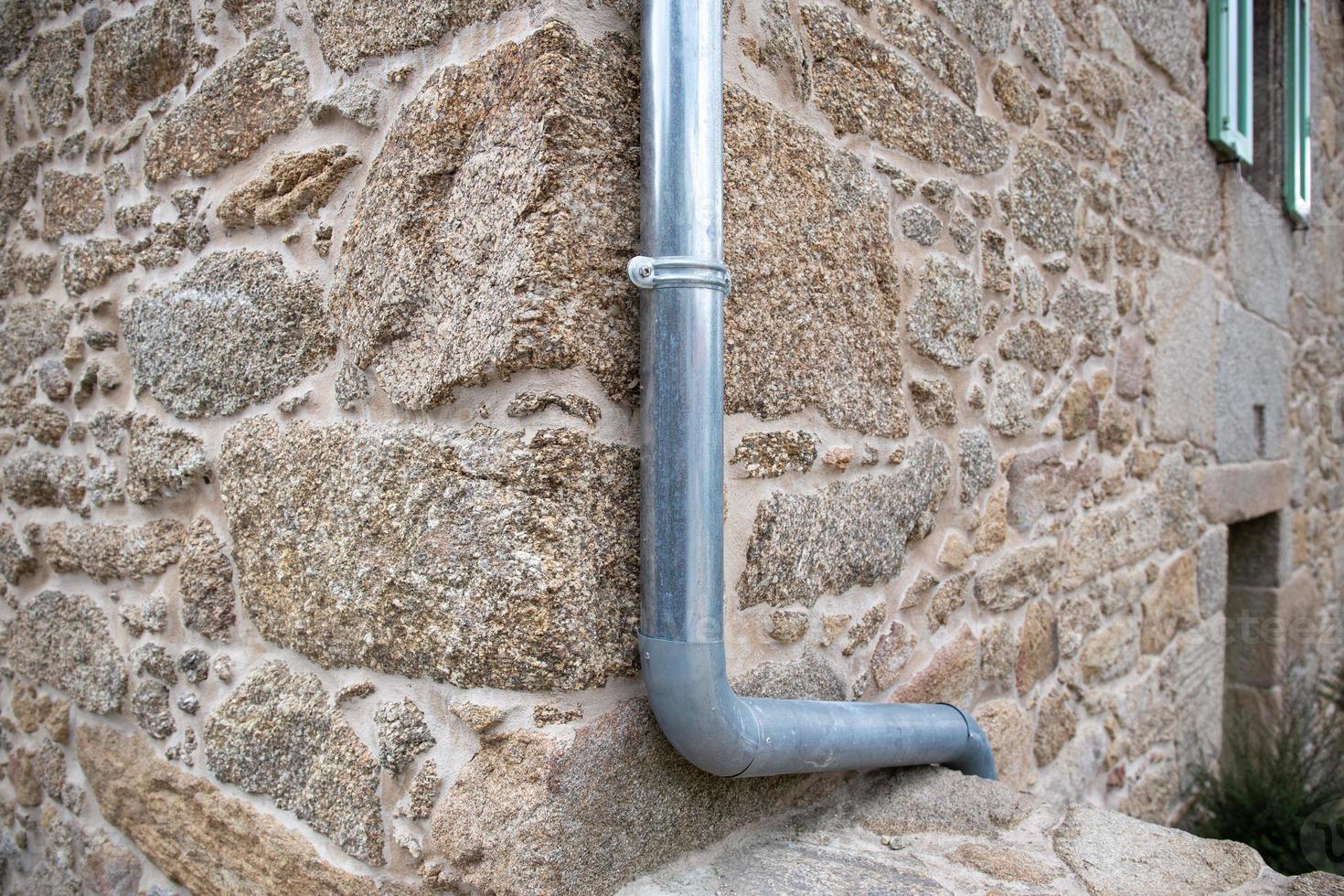 Rain Water Draining Gutter of a antique stone house. Galicia, Spain photo