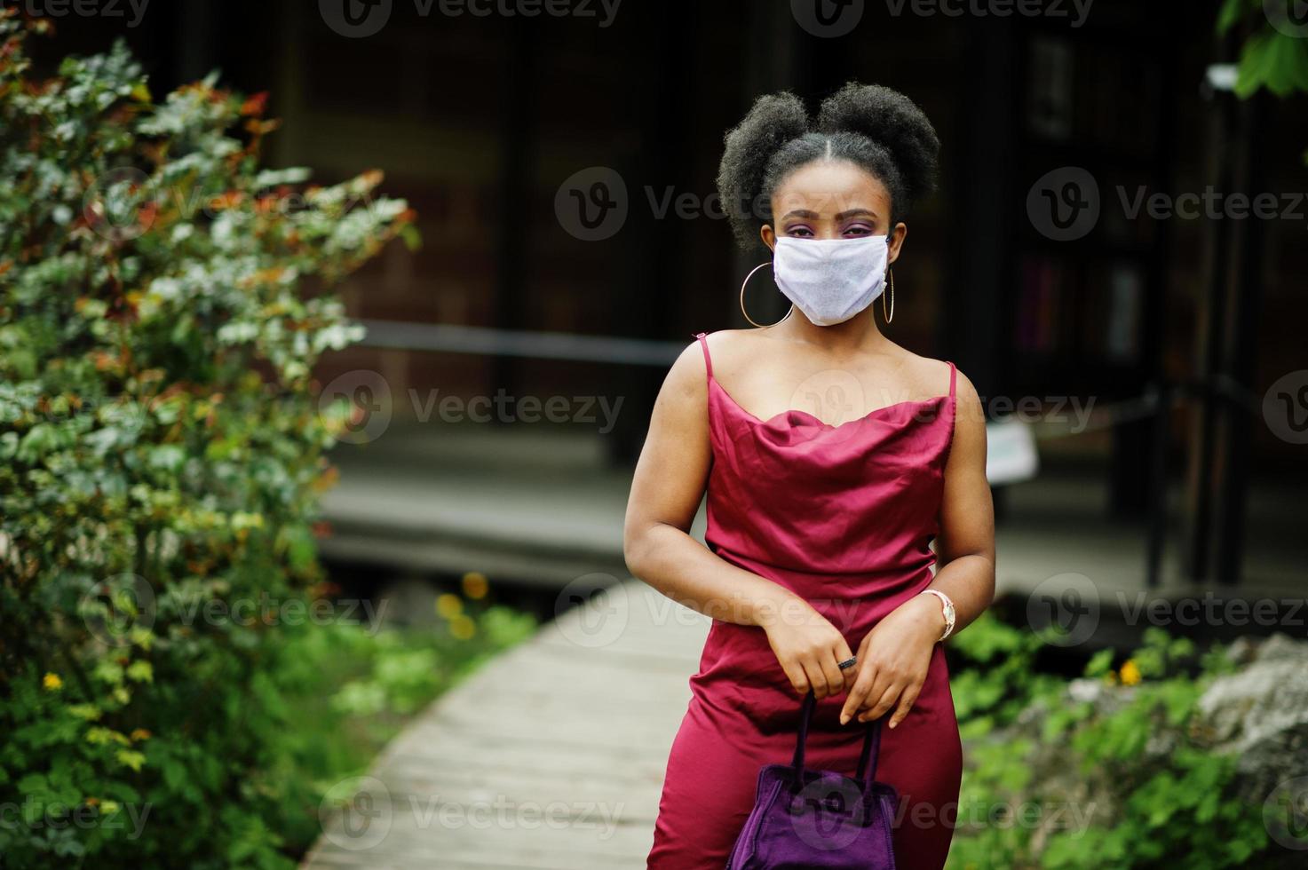 Covid-19, infectious virus. African woman with curly hair, wears red silk  dress and medical disposable mask, cares about her health and protects in  dangerious situation. 10511555 Stock Photo at Vecteezy