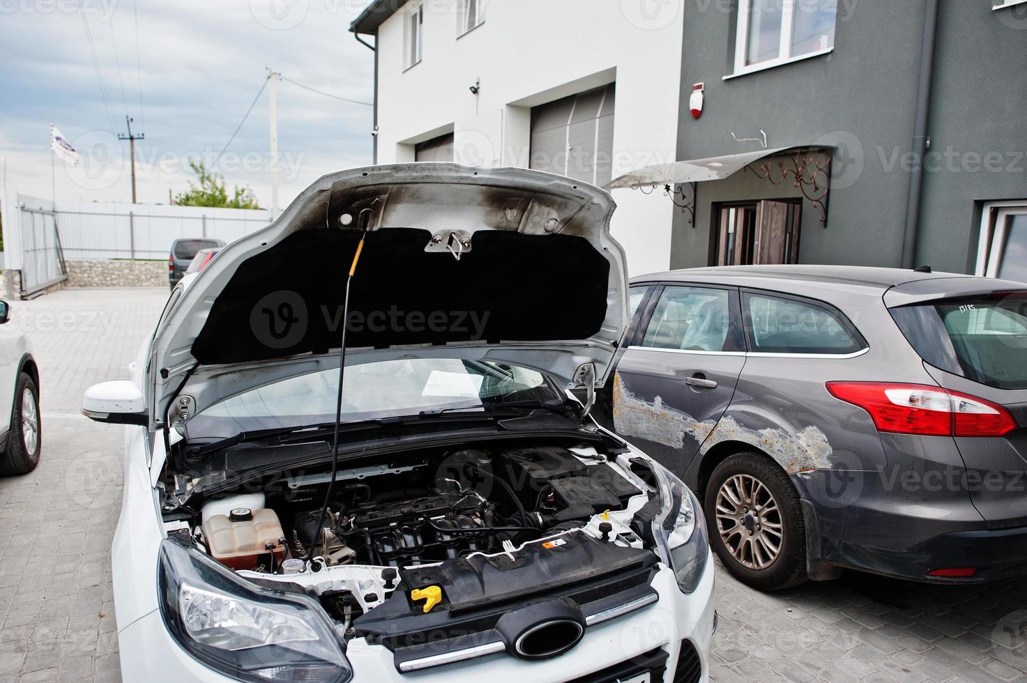 Car repair and maintenance theme. Open hood engine in auto service. photo