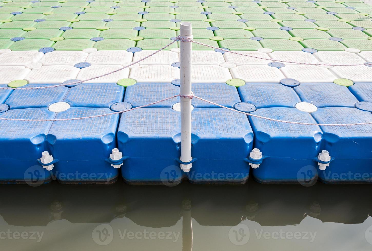 Plastic pontoon with the rope fence. photo