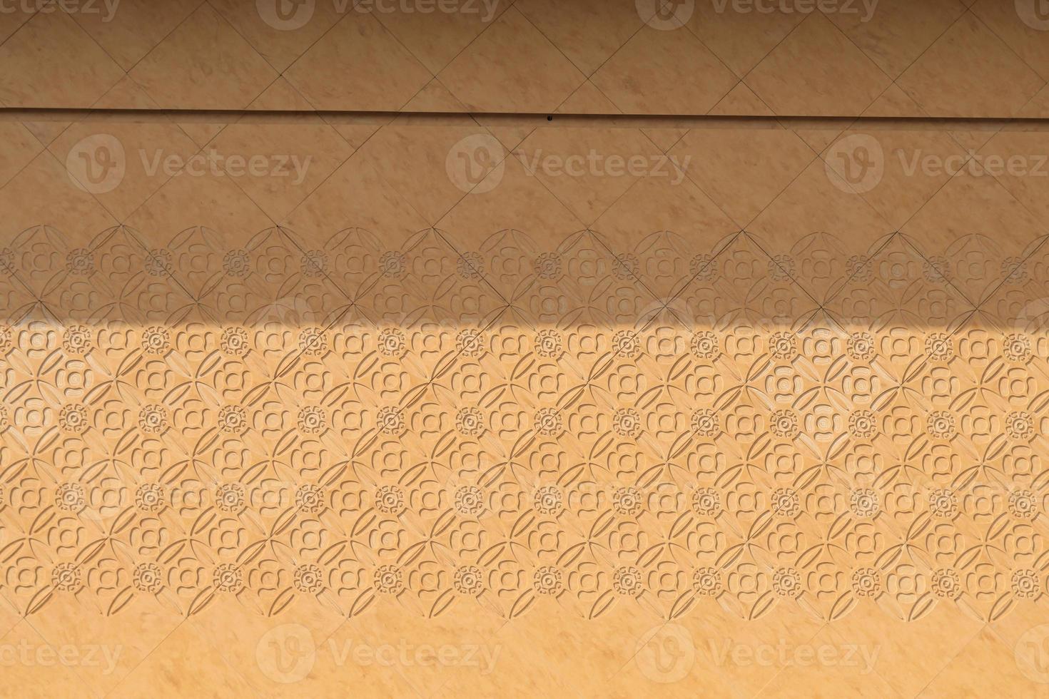 yellow wall that was built in front of the building is a interpretive artwork and is punched into a kind of print and is a beautiful natural marble floor created by the painter. photo