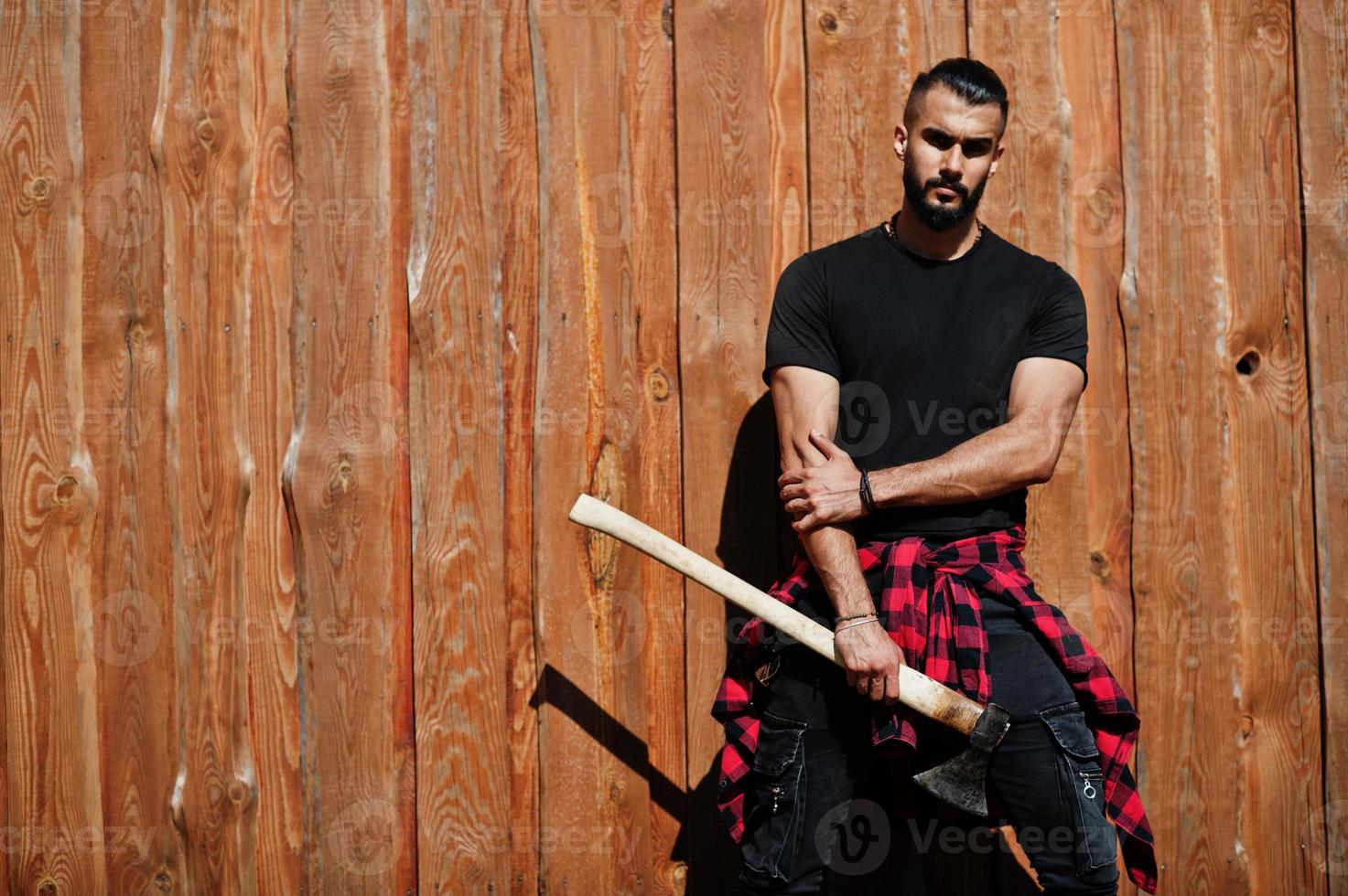 Arab hipster beard man lumberjack hold axe. photo