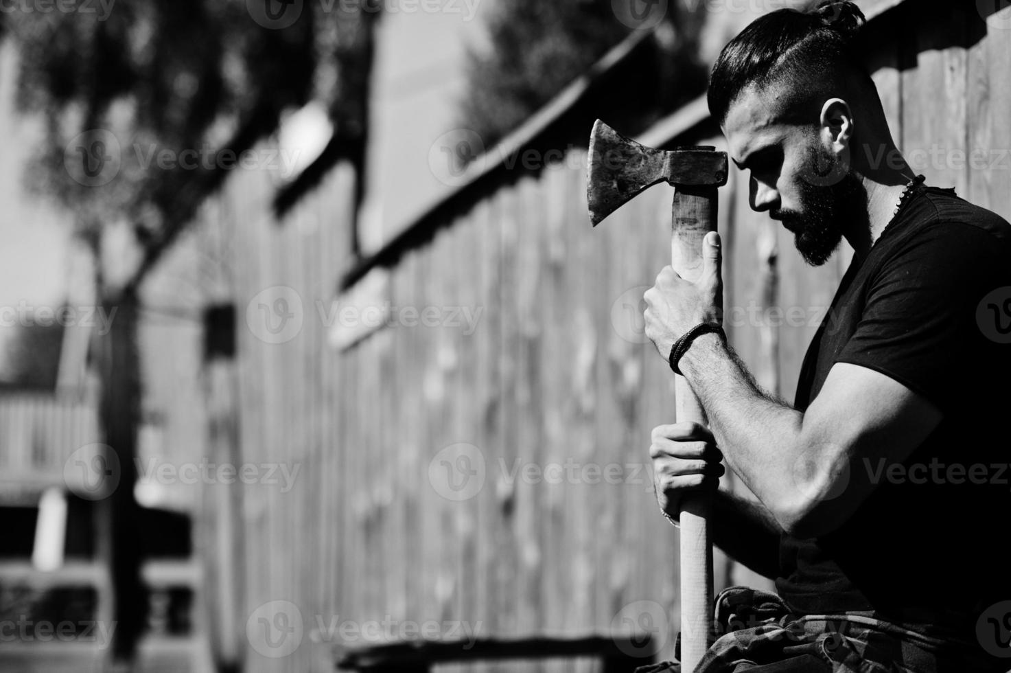 Arab hipster beard man lumberjack hold axe. photo