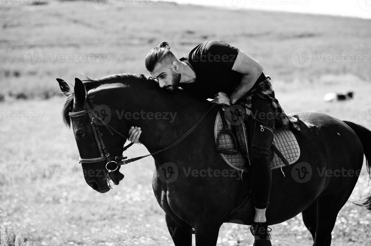 Arab tall beard man wear in black ride arabian horse. photo