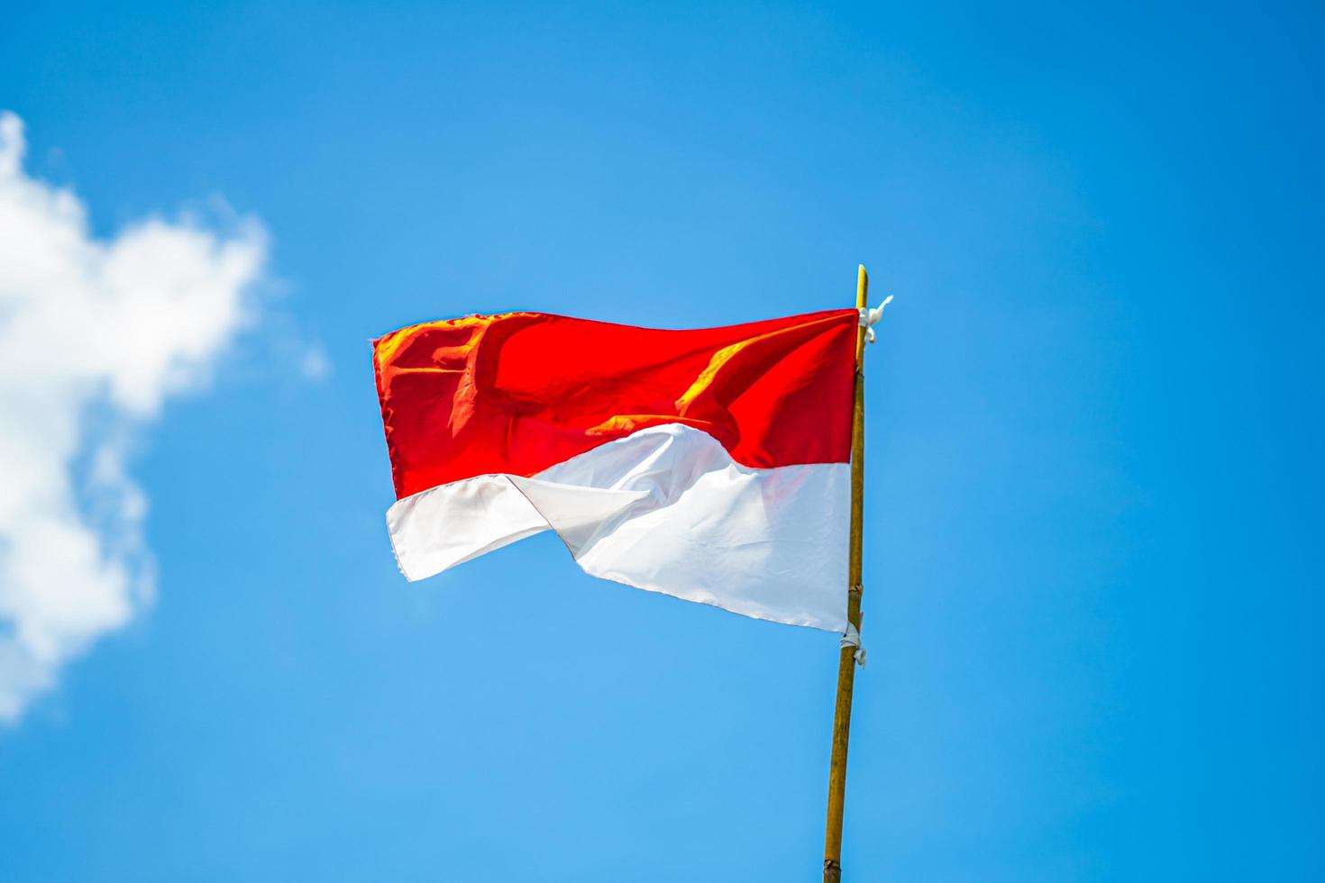 Indonesian flag with sky background photo
