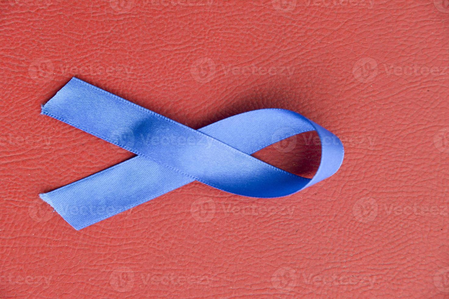 Blue ribbon in red background photo