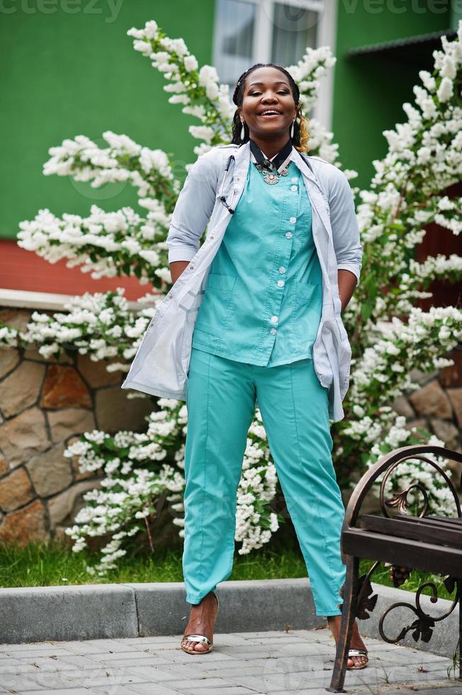 Portrait of African American female doctor with stethoscope wearing lab coat. photo