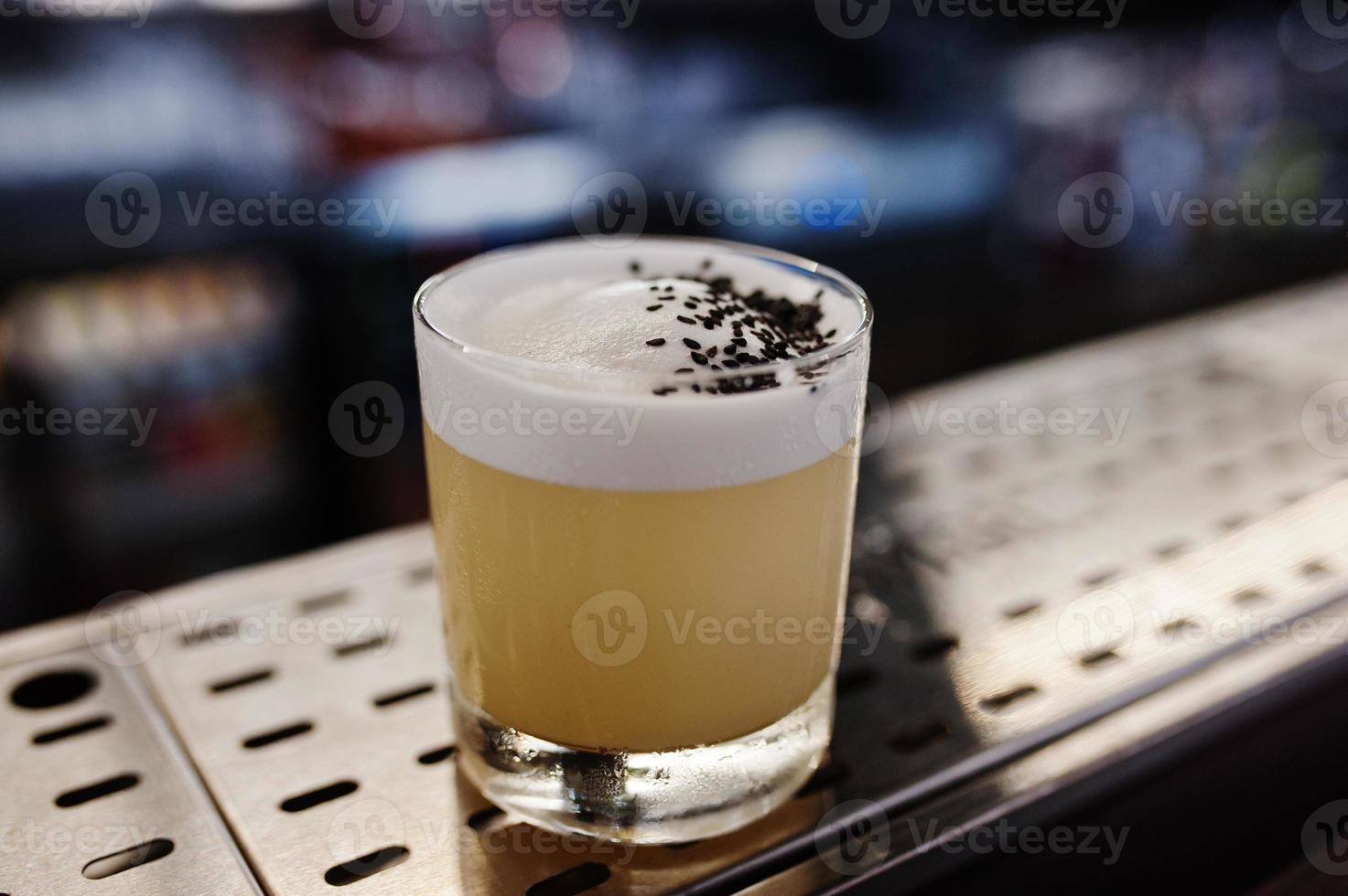 Alcoholic cocktail in glass on bar table. photo