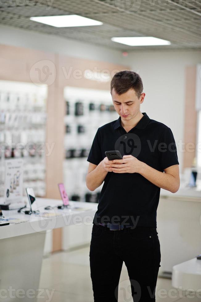 Seller man mobile phone professional consultant in tech store or shop. photo