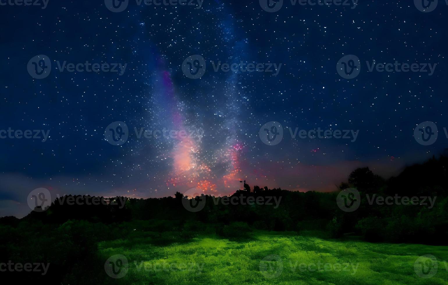 Milky Way and pink light at mountains. Night colorful landscape. Starry sky with hills at summer. Beautiful Universe. Space background with galaxy. Travel background photo