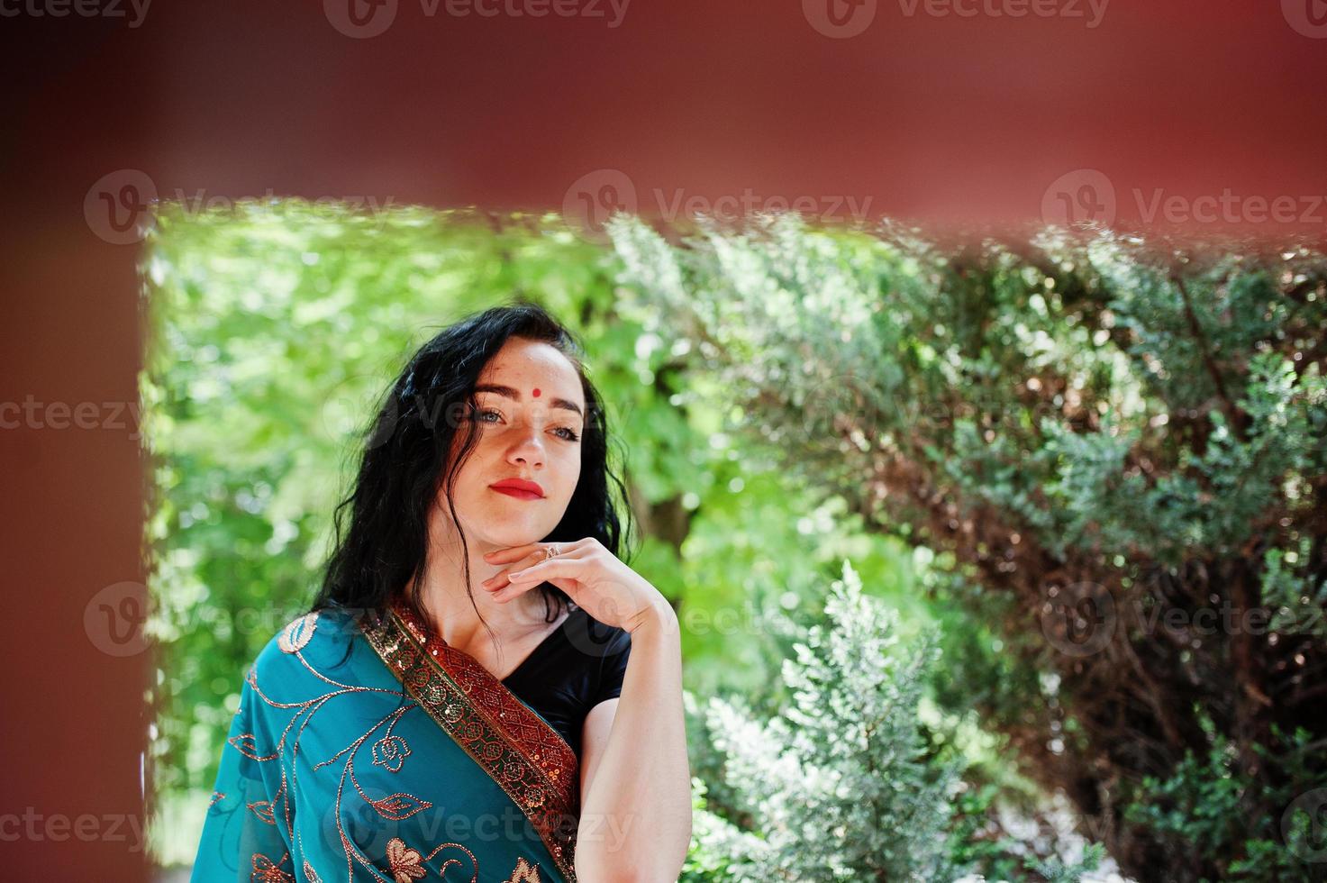 Portrait of beautiful indian brumette girl or hindu woman model. Traditional Indian costume lehenga choli. photo