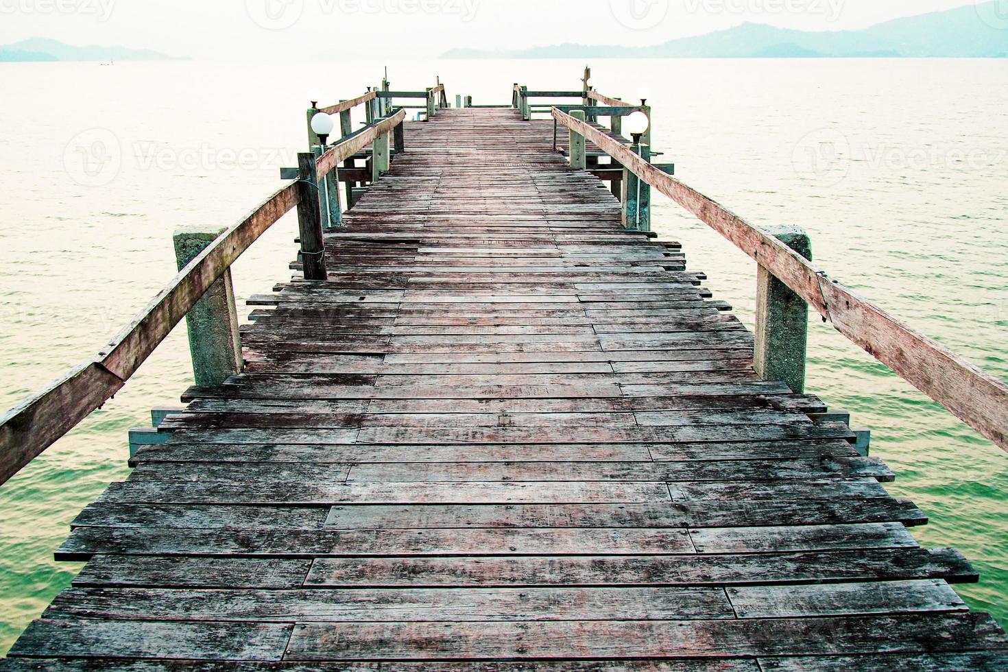 A wooden walkway that stretches into the sea. vacation travel concept photo