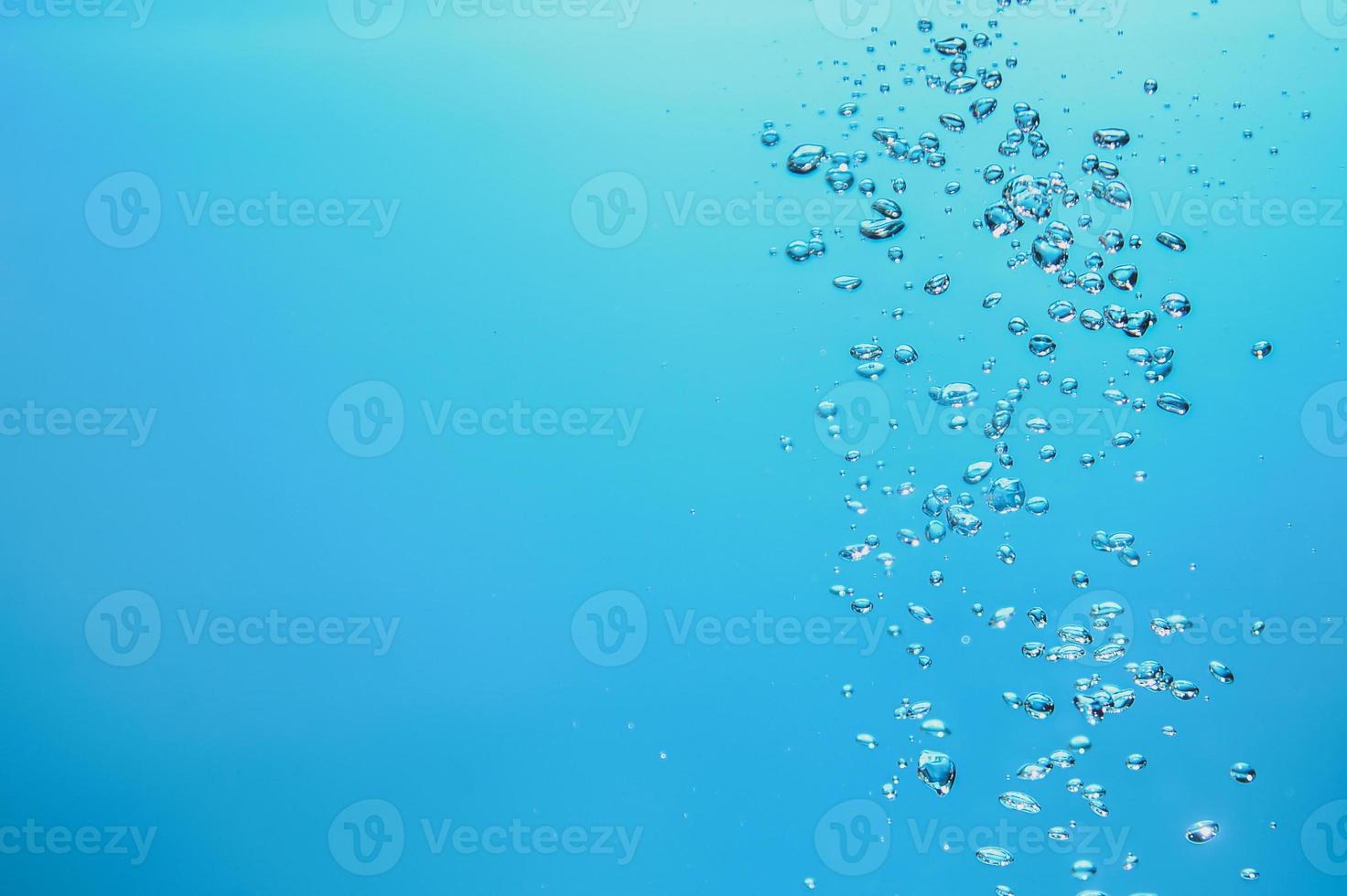 Abstract background image of bubbles in water. Clean water with water droplets and waves. Fresh water a glass with bubbles blue background. photo