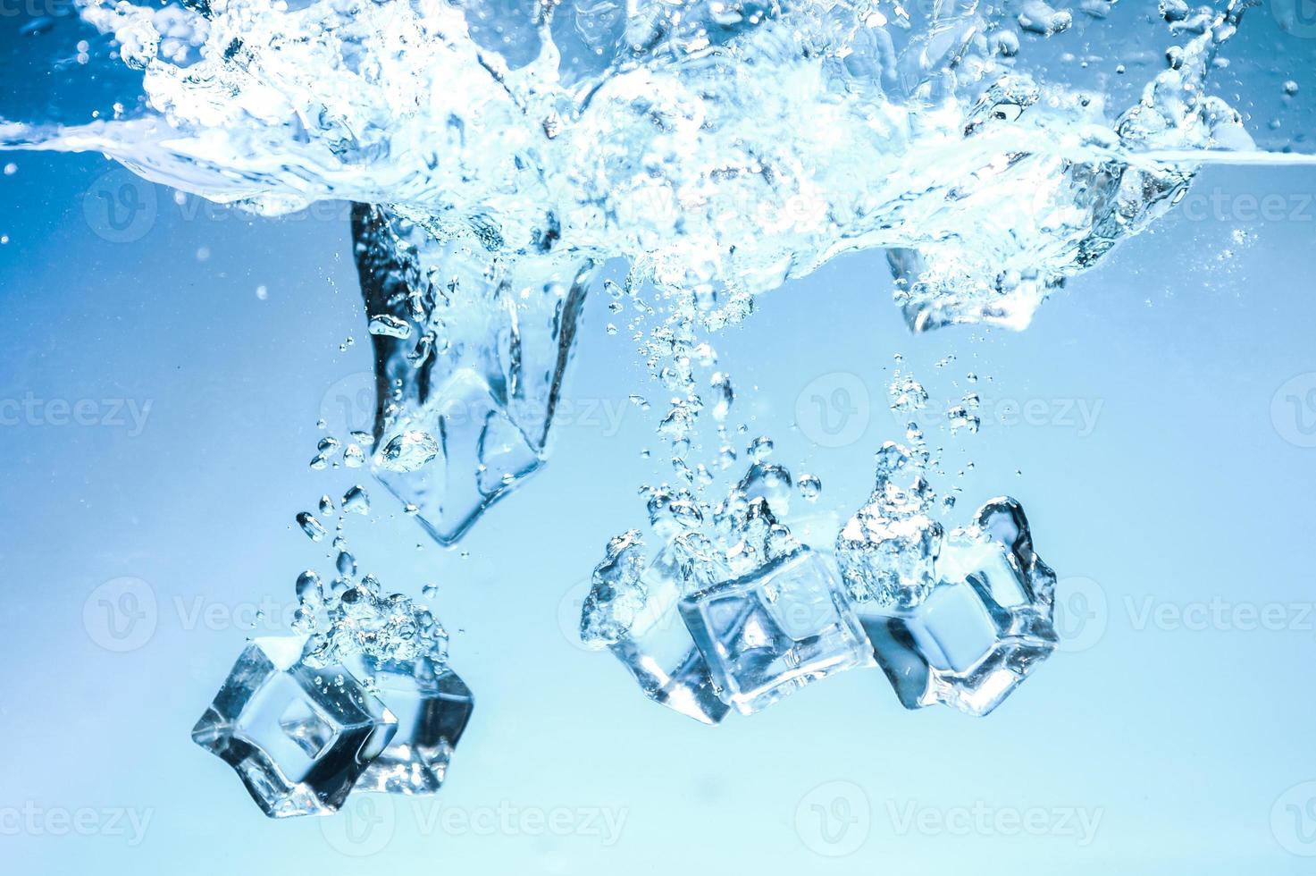 Abstract background image of ice cubes in blue water. photo