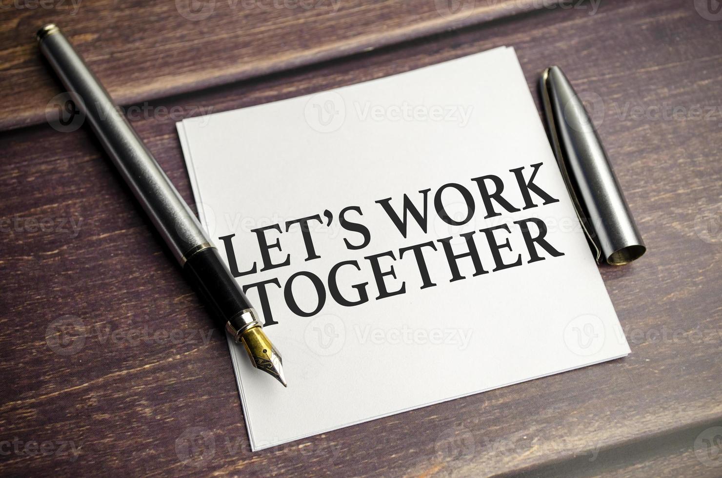 let's work together text concept write on notebook on a wooden background photo