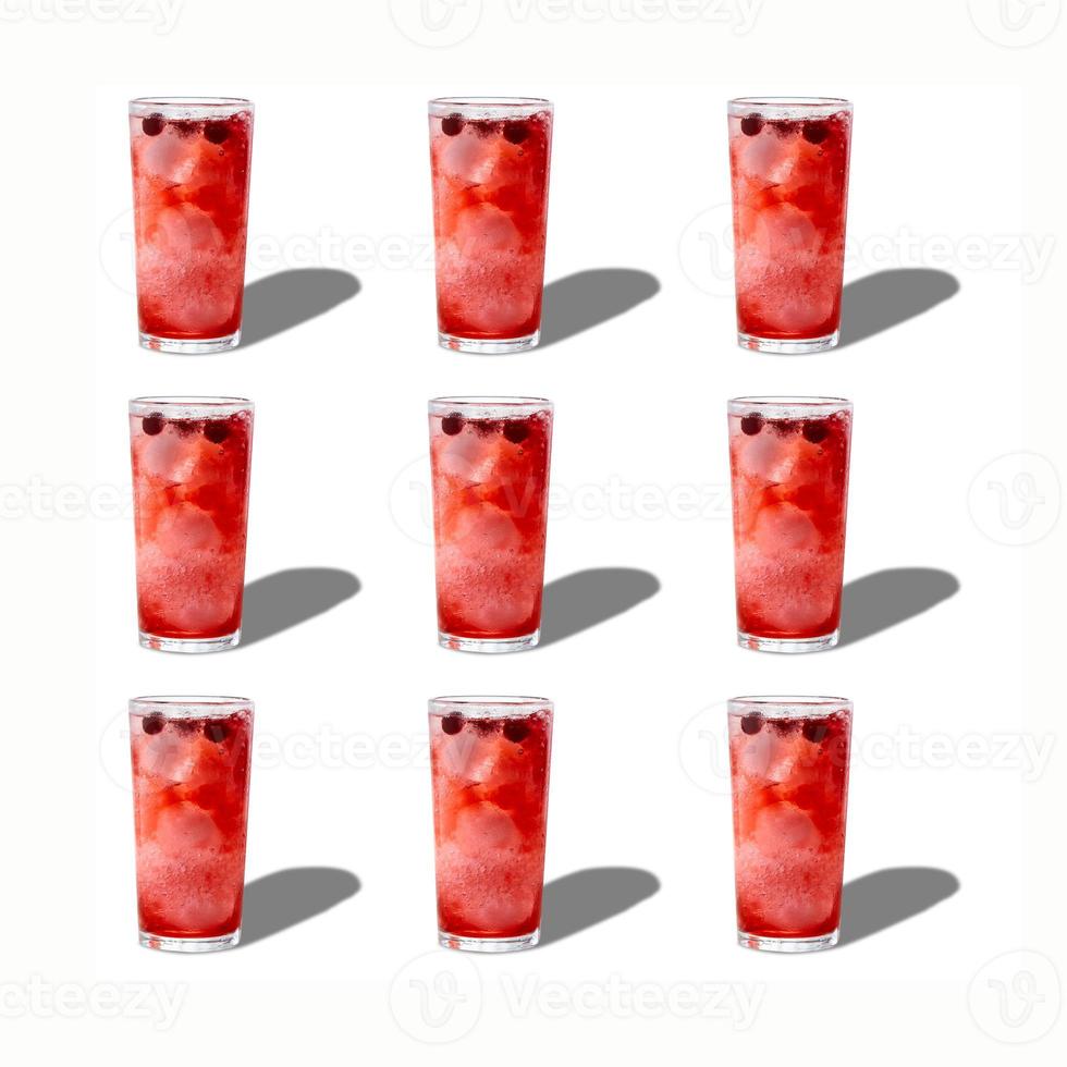 A pattern of glasses with berry lemonade isolated on a white background. The concept of summer drinks. photo