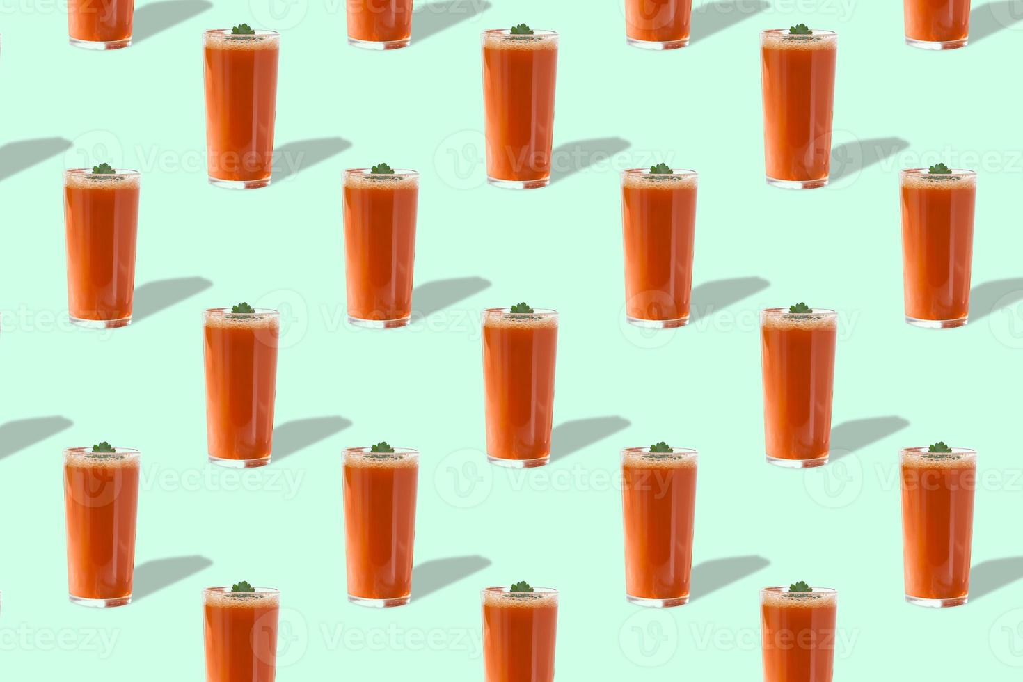 Tomato juice in glass with greens isolated on light green background. Seamless pattern. photo