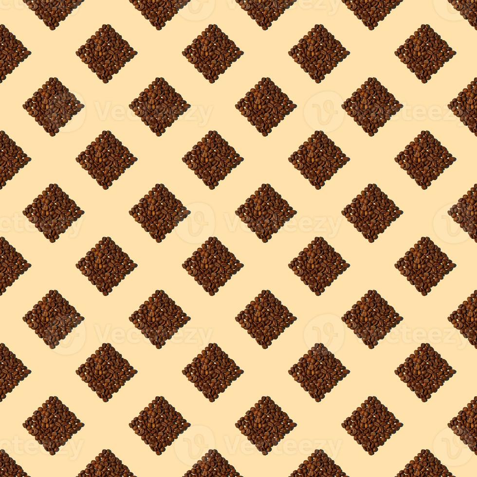 Squares from coffee grains on light yellow background. A seamless pattern of coffee beans poured in the form of squares. photo