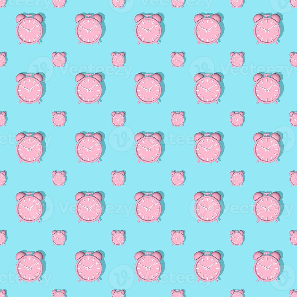 Pink alarm clocks big and small with shadow on blue background. Set. Seamless texture pattern. 3D illustration. photo