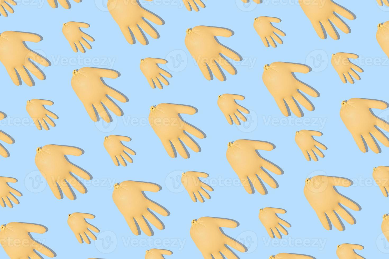 Seamless pattern with inflated yellow medical gloves on a blue background. Prevention and protection of coronavirus, covid-19. Healthcare concept. Abstract background. photo