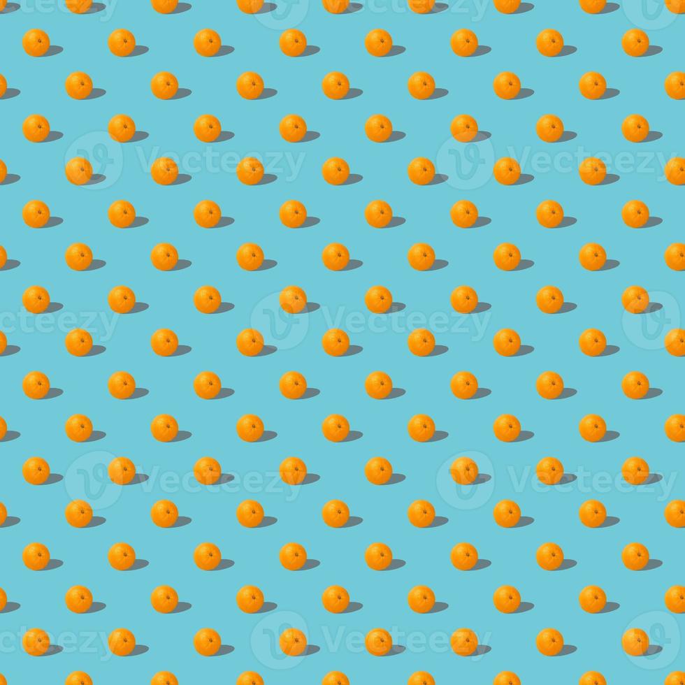Fruit seamless pattern of fresh oranges on blue background. Pop art design, creative summer concept. photo