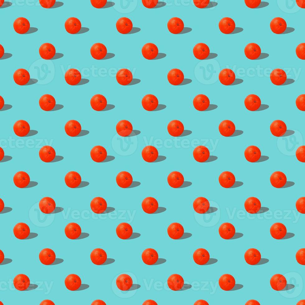 Fresh red orange or grapefruit on blue background. Pattern seamless tropical fruit photo. photo