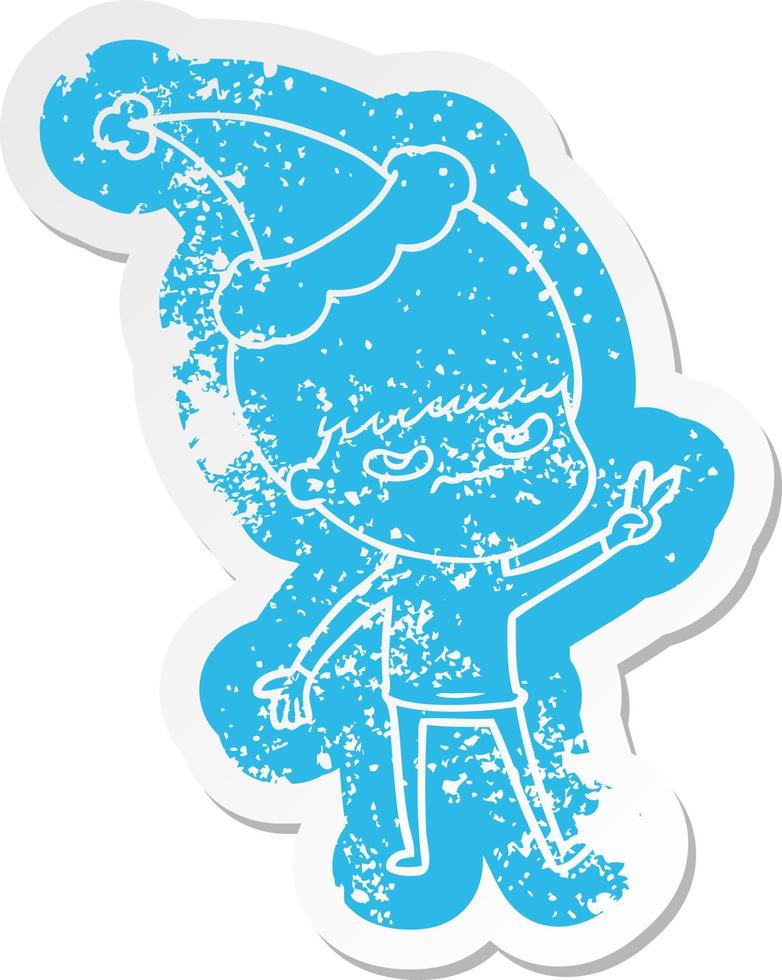 annoyed cartoon distressed sticker of a boy wearing santa hat vector