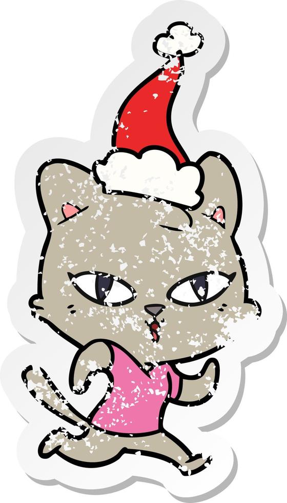 distressed sticker cartoon of a cat out for a run wearing santa hat vector