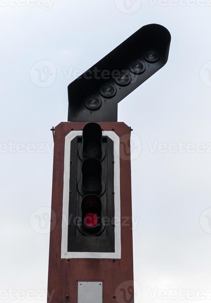 Closeup of the railway traffic light for controlling the train before entering the station. photo