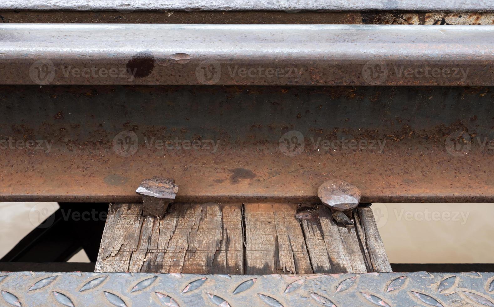 Closeup of the railway and metal peg. photo