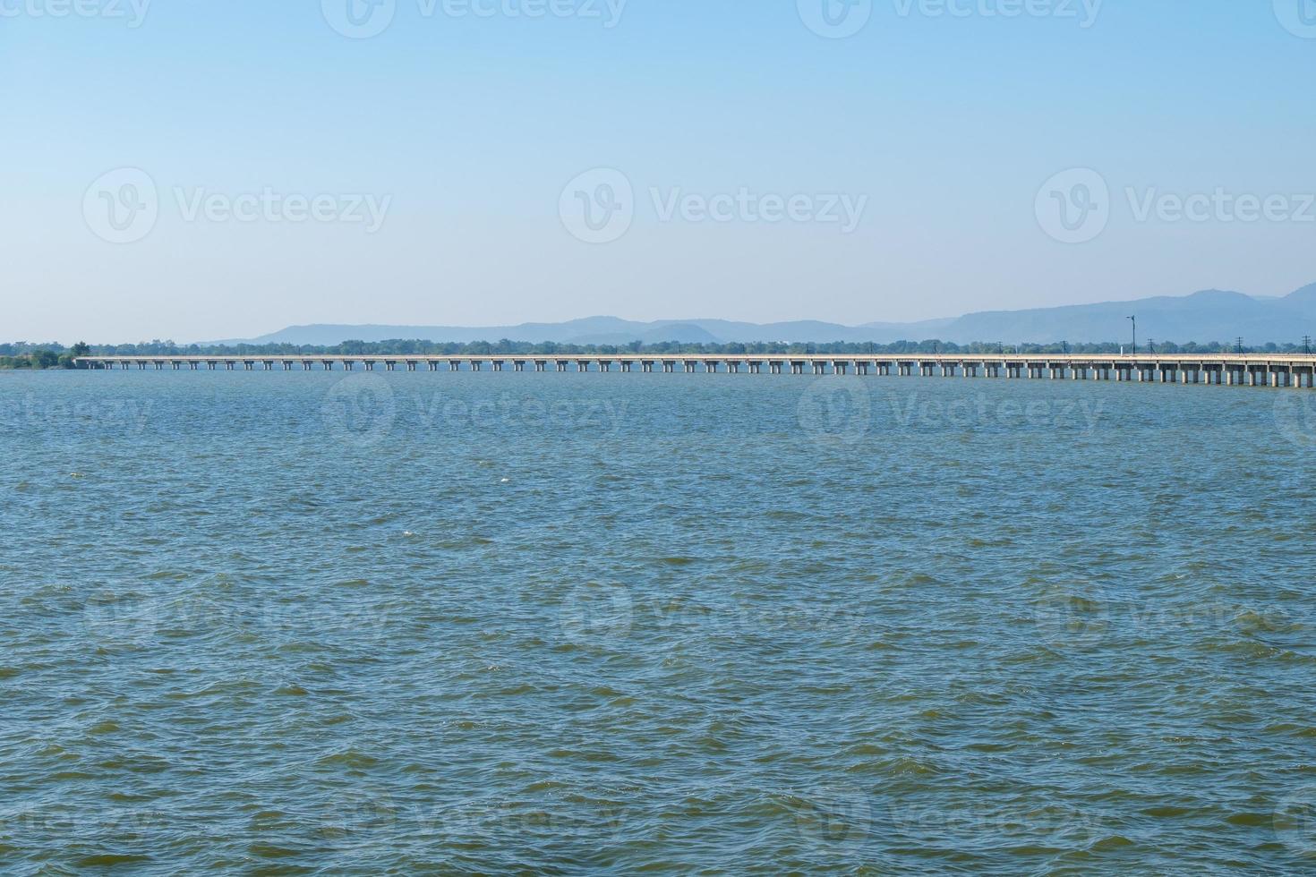 The long concrete bridge of the railway line across the large reservoir. photo