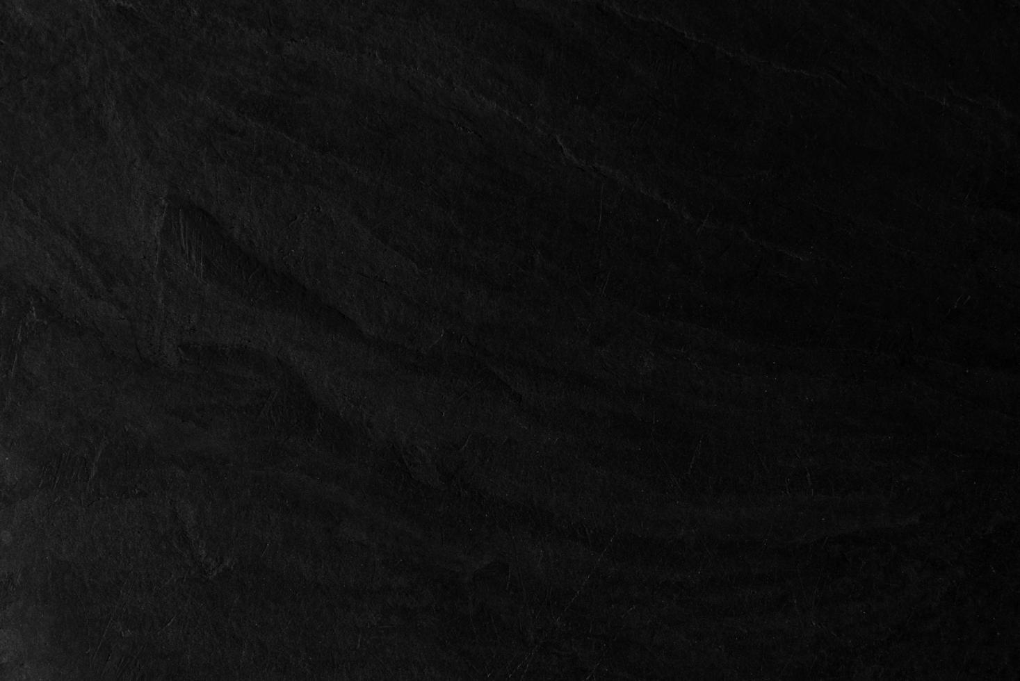 Surface of the black stone texture rough, gray-black tone. Use this for wallpaper or background image. There is a blank space for text photo