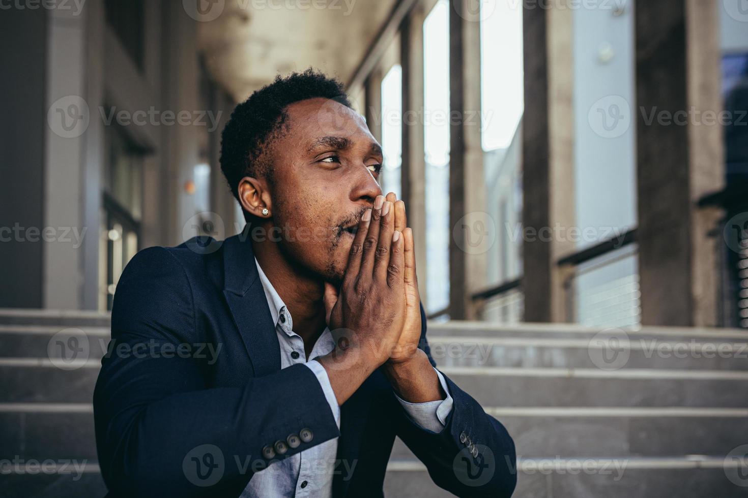 Male office worker tired after work, African American has severe headache, sitting photo