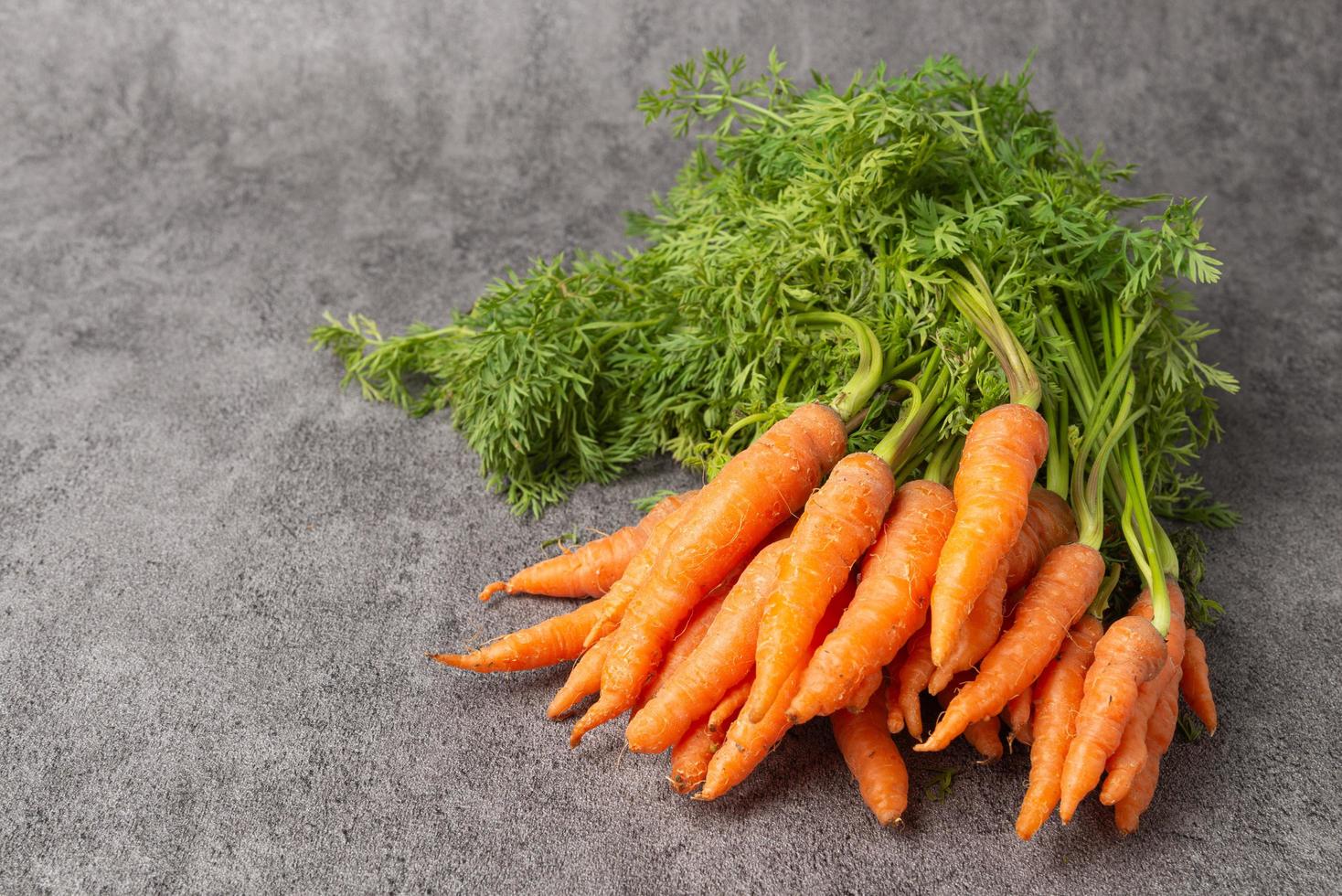 Fresh carrot on stone background. photo