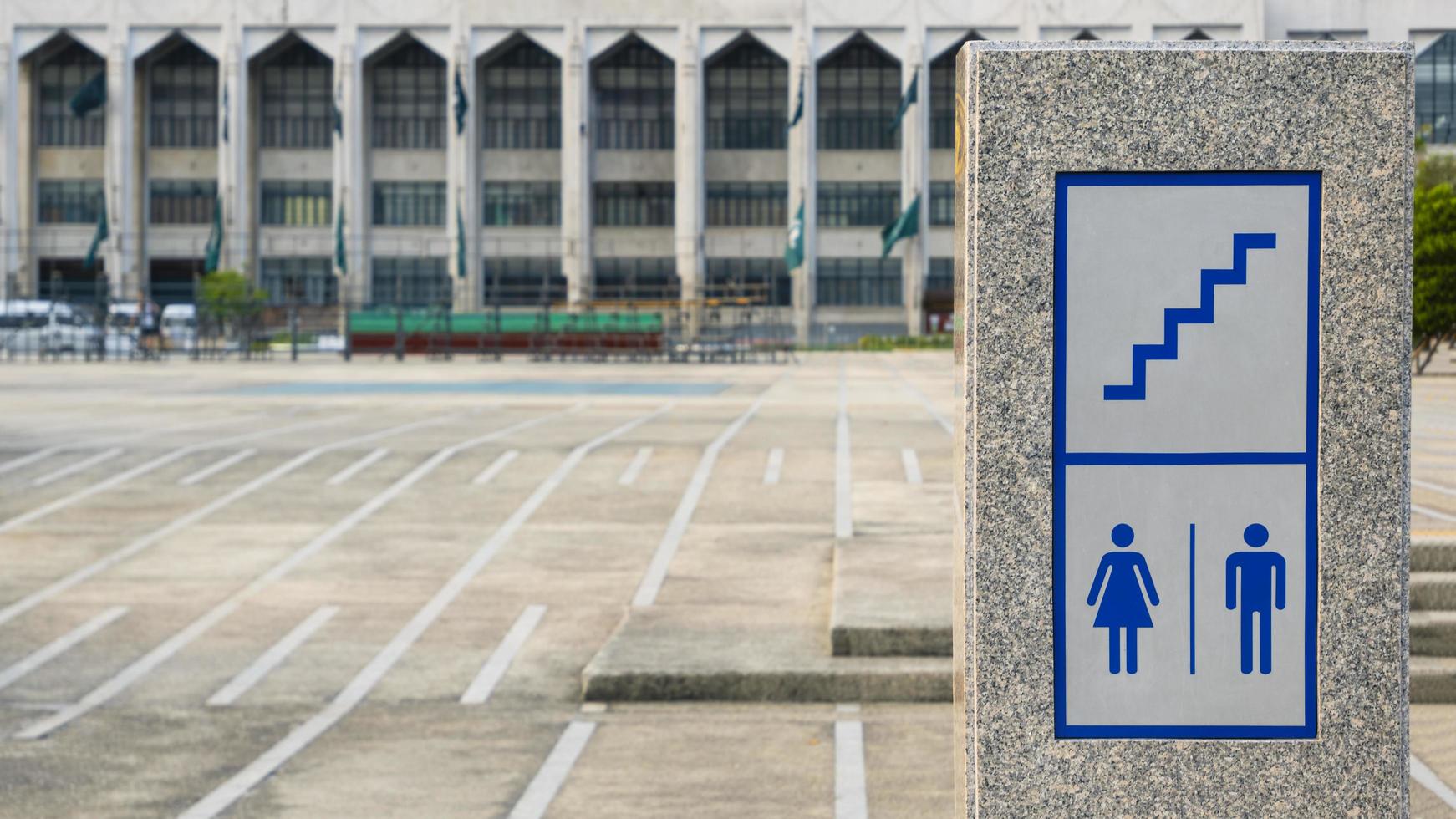 Bangkok, Thailand, 2020 - Stairway with restroom signs on marble podium on courtyard area in front of Bangkok metropolitan administration photo