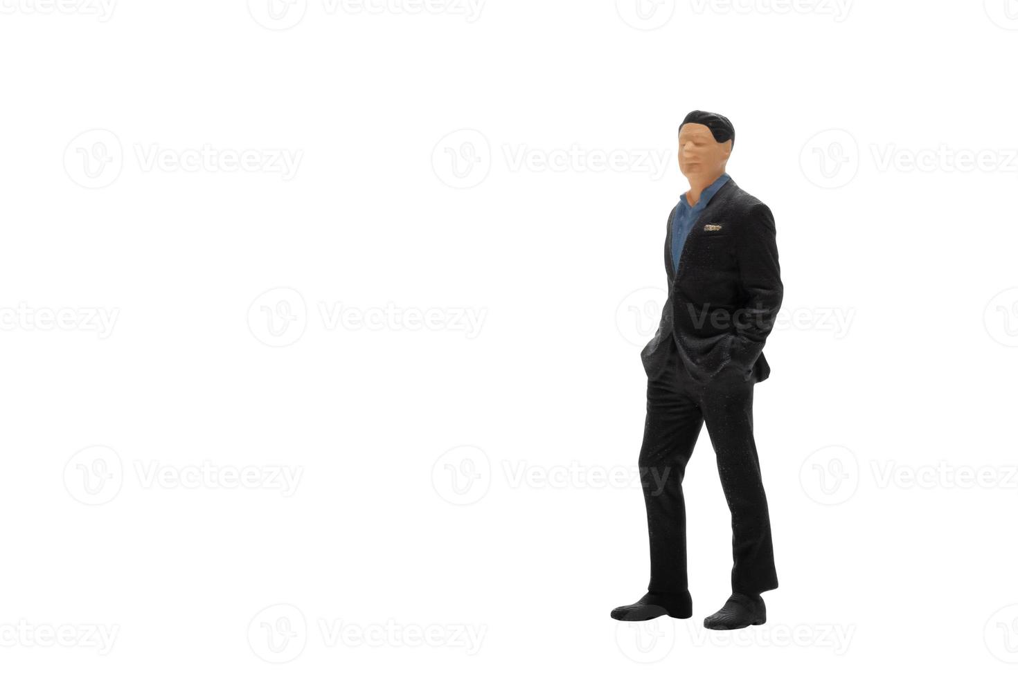 Miniature people businessman wearing black suit with clipping path photo