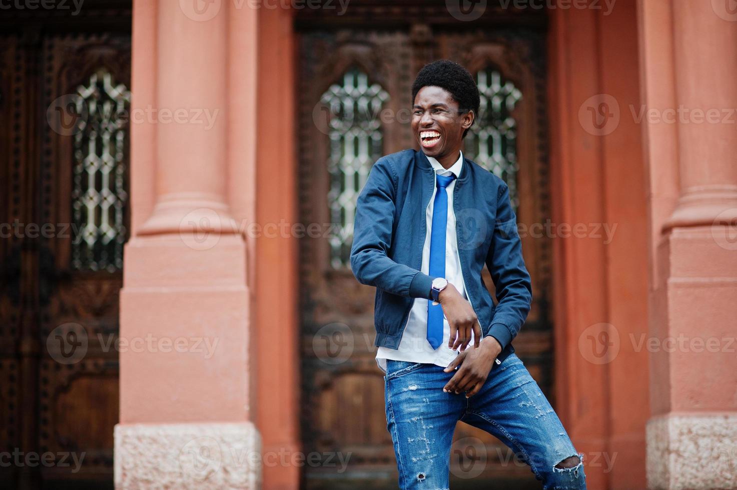 African man wear in tie and casual outfit posing outdoor. photo