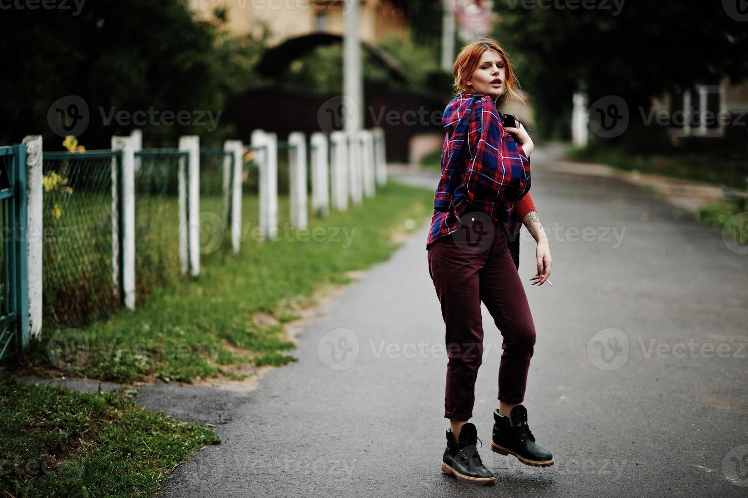 Fashion portrait of redhaired sexy girl outdoor. Model attractive seduction woman with cigarette. photo