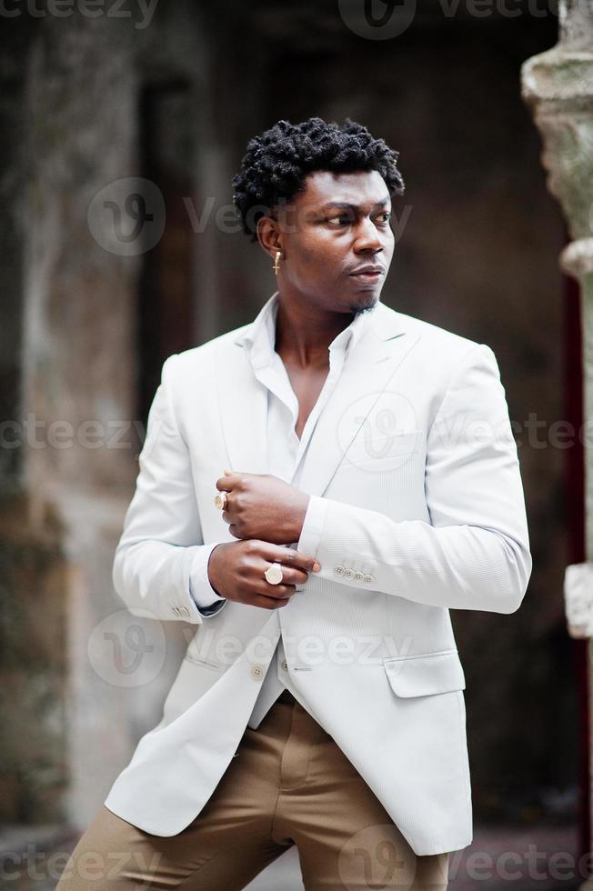 Thoughtful young handsome african american gentleman in formalwear. Black stylish model man in white jacket. photo