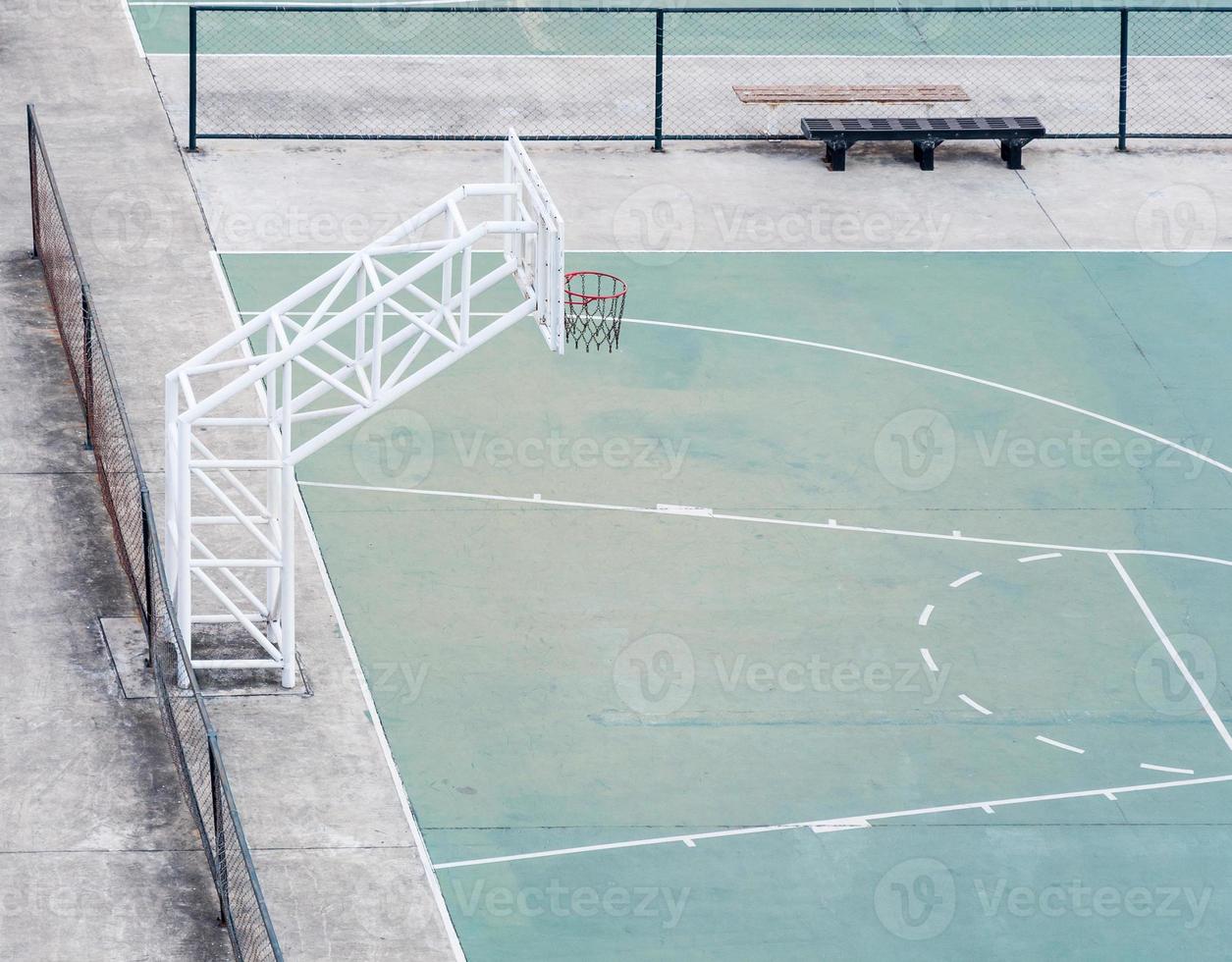 Empty basketball field with the old fence. photo