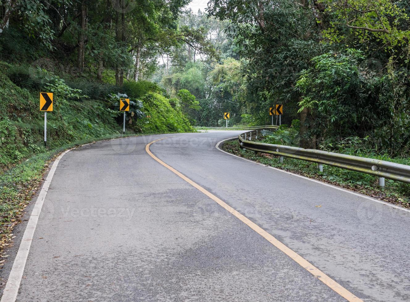 Curve asphalt road with the directional sign. photo