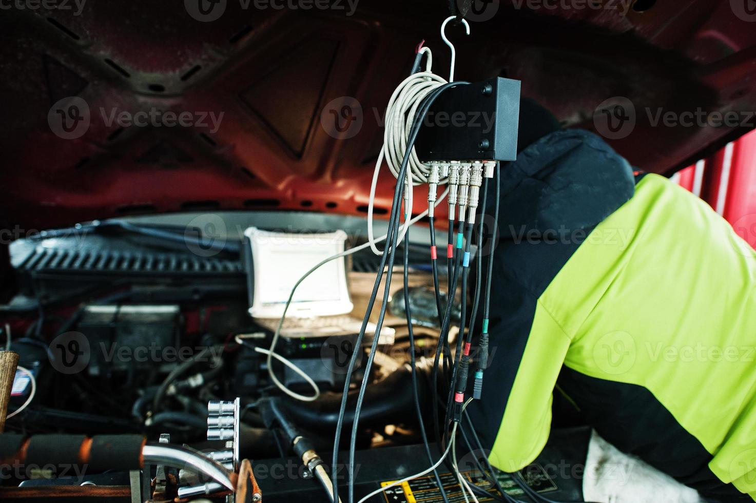 Auto mechanic sets american SUV car for diagnostics and configuration in workshop service station.. photo