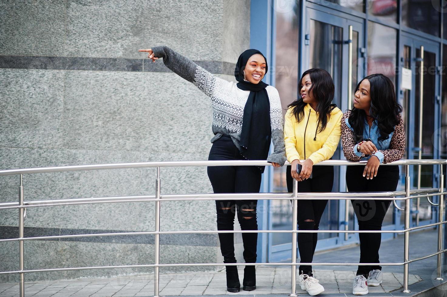 Three young college african american woman friends spend time together. photo