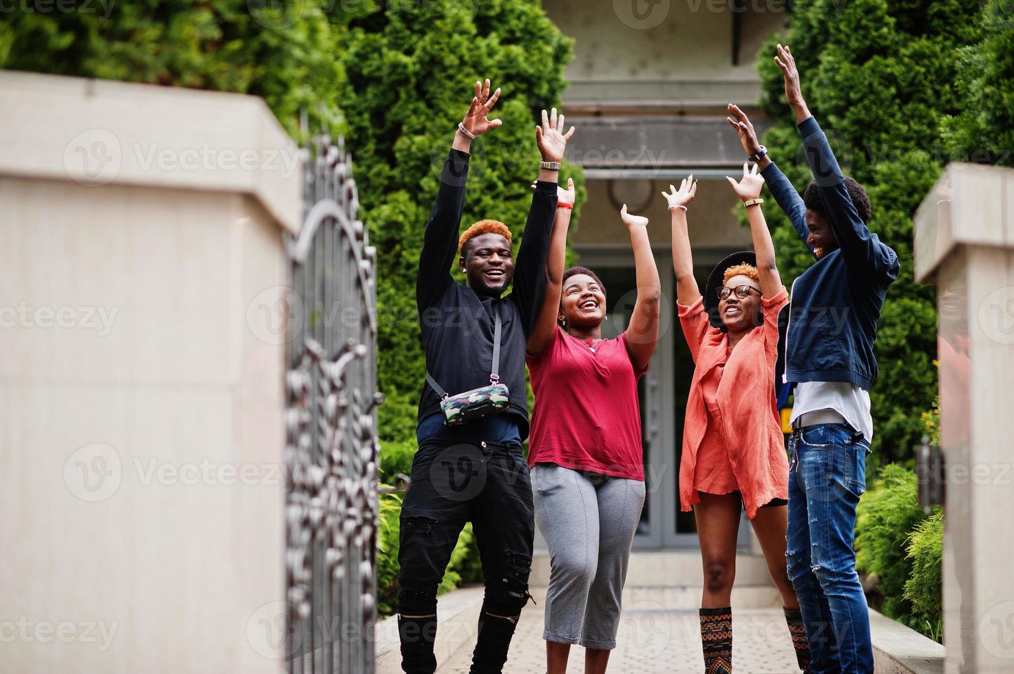 Four african friends having fun outdoors. Two black girls with guys. photo
