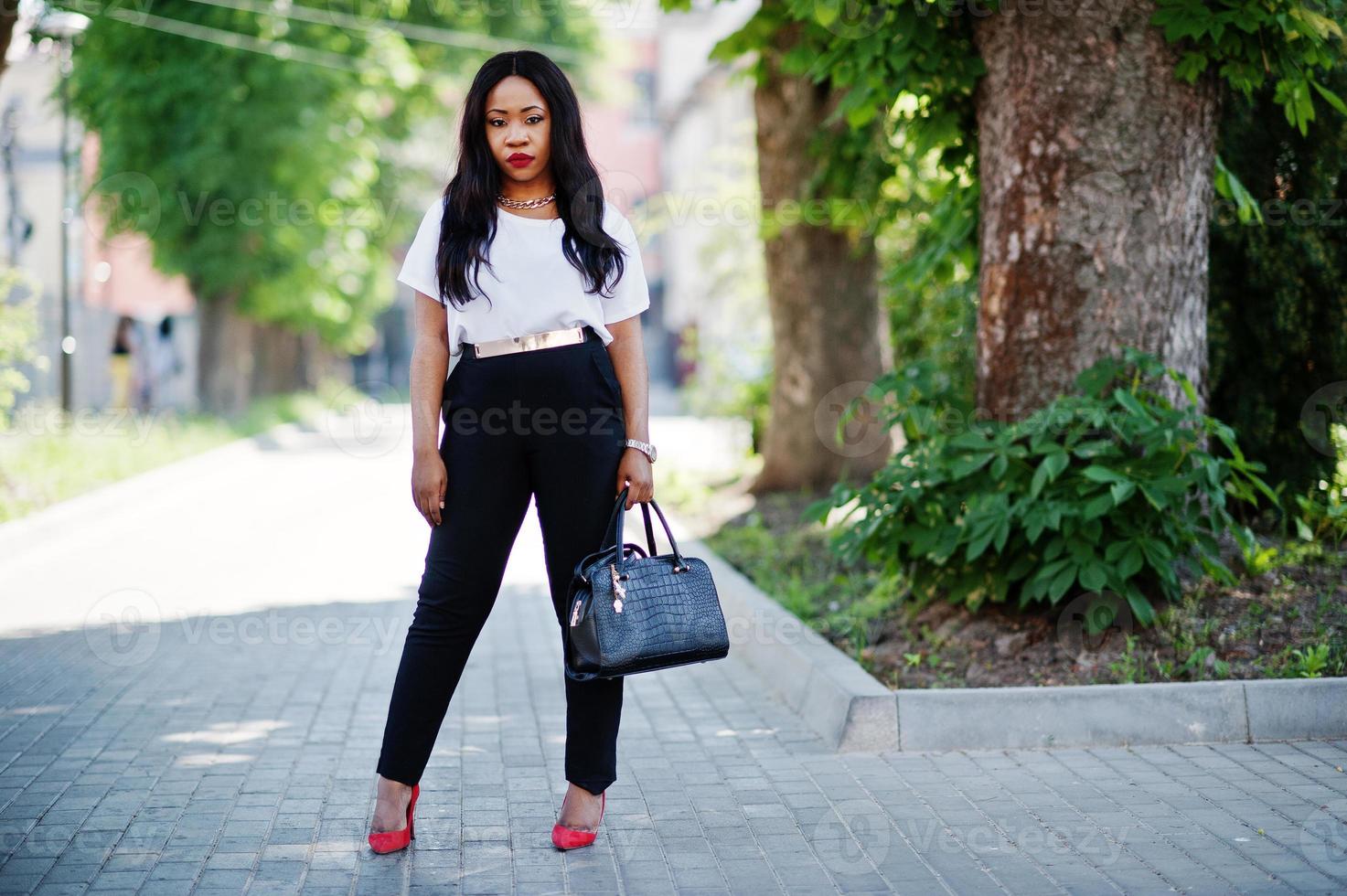 Stylish african american business woman on streets of city. photo