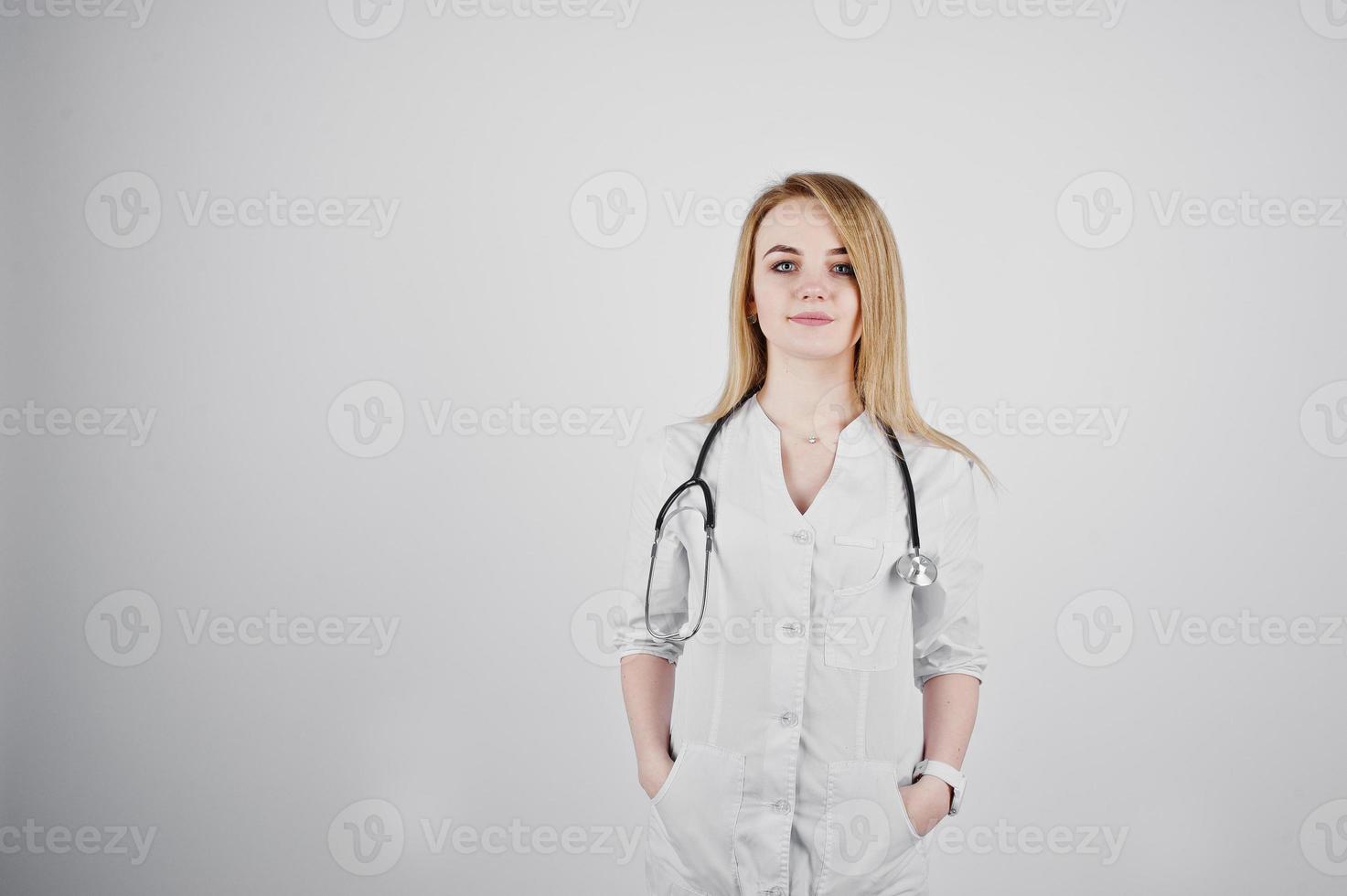 Blonde doctor nurse with stethoscope isolated on white background. photo