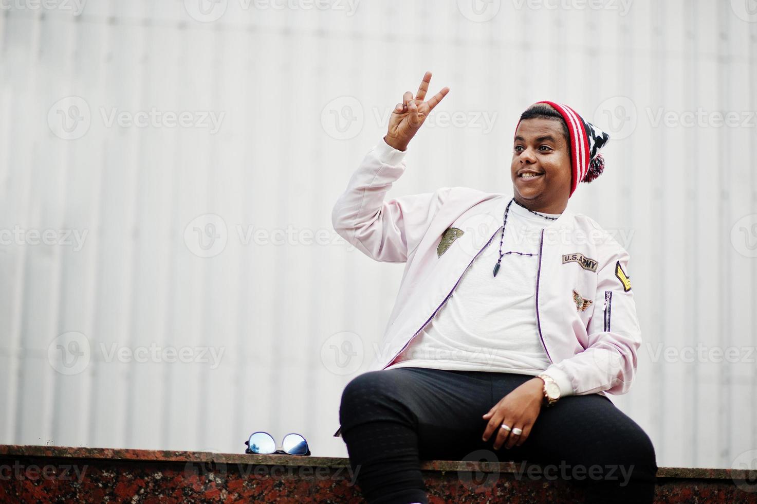 Stylish hipster arab man guy posed outdoor in street. Style rap singer. photo