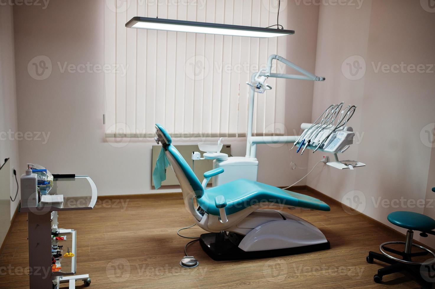 Dental chair by dentists in blue with medic light. Modern dental practice. photo