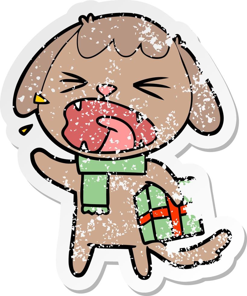 distressed sticker of a cute cartoon dog with christmas present vector