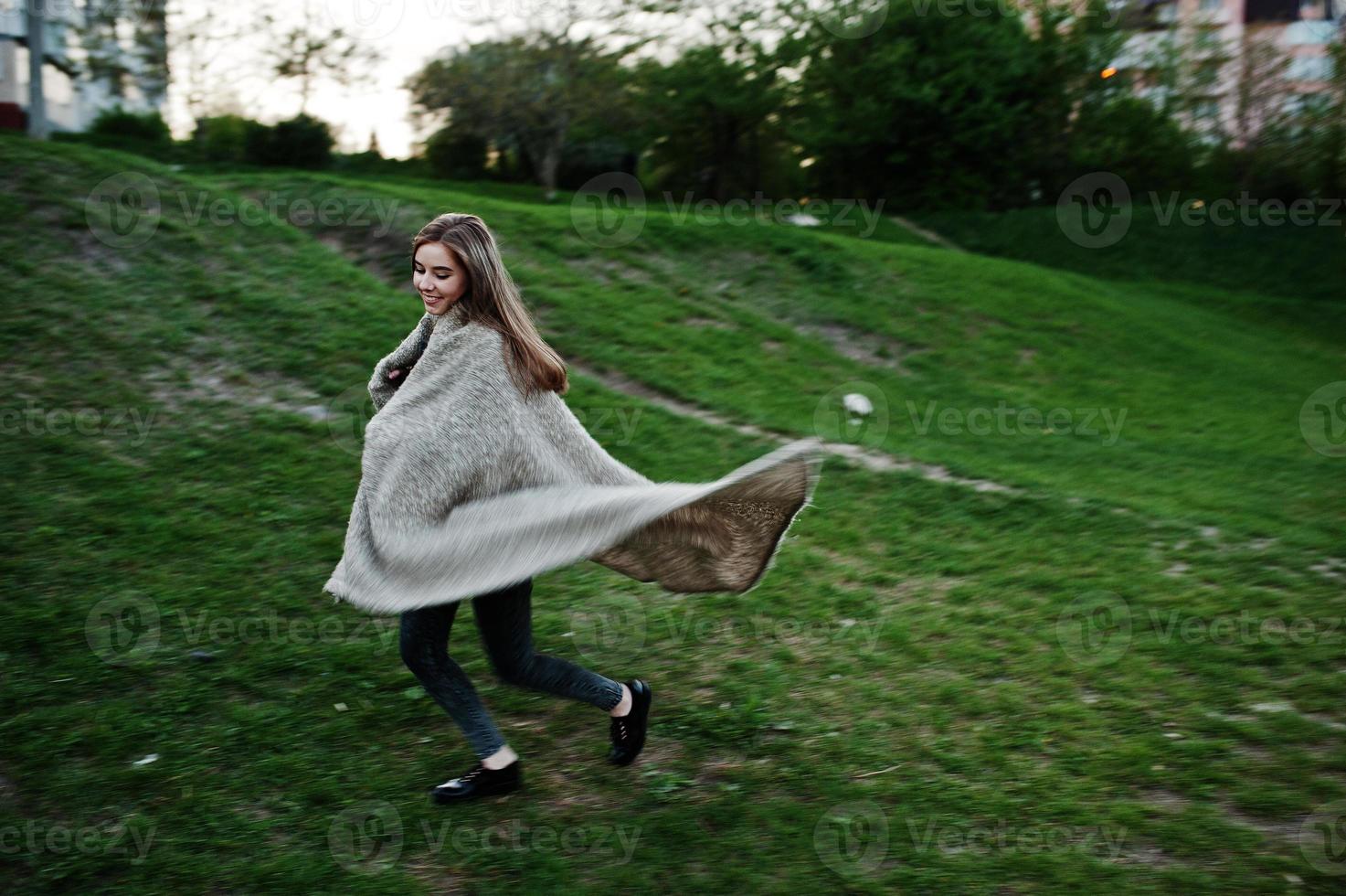 Young brunette girl on plaid having fun at evening spring day. photo